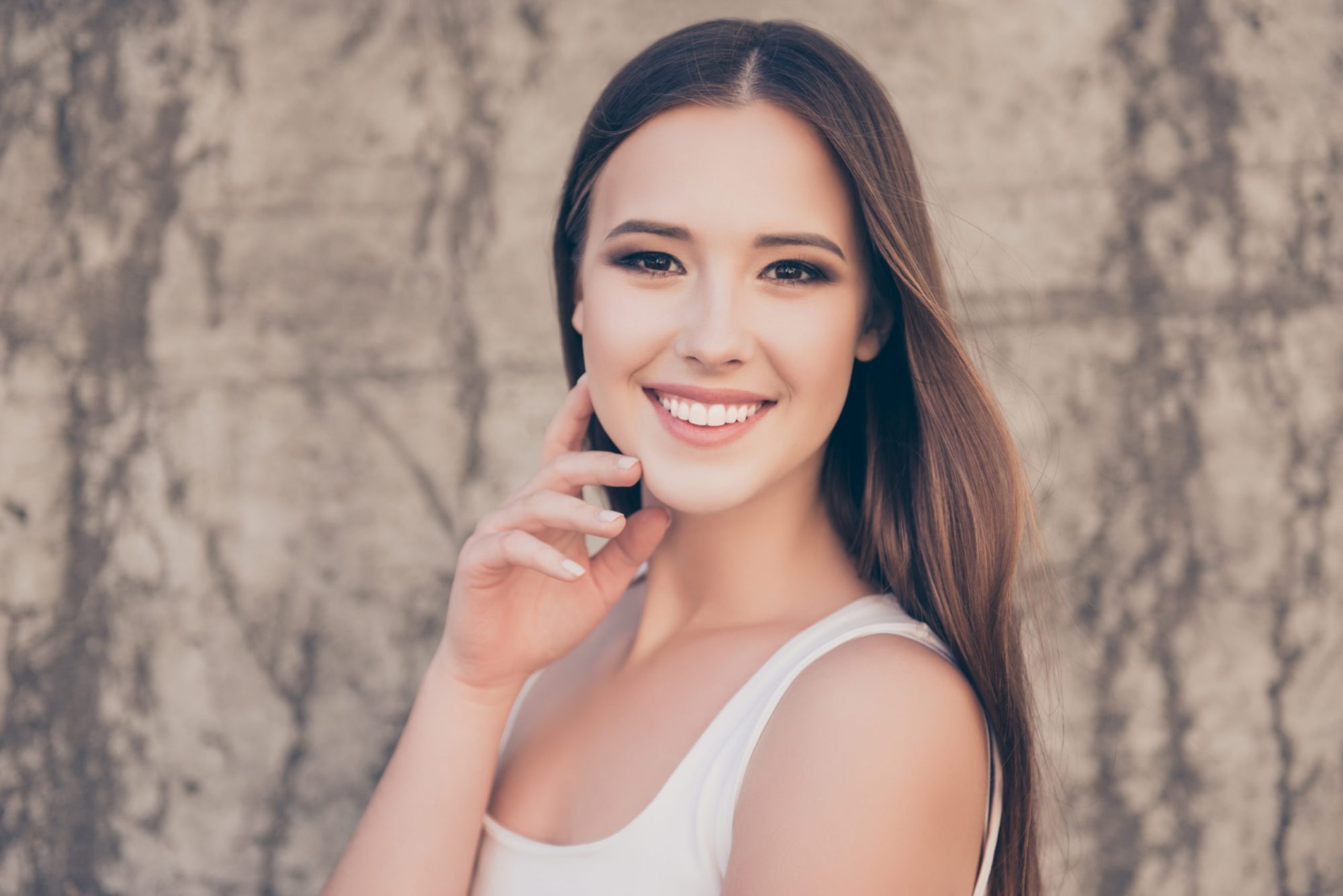 Smiling young woman with clear aligners showcasing a beautiful smile, emphasizing orthodontic care from Johnston Family Orthodontics in Crosby, TX.