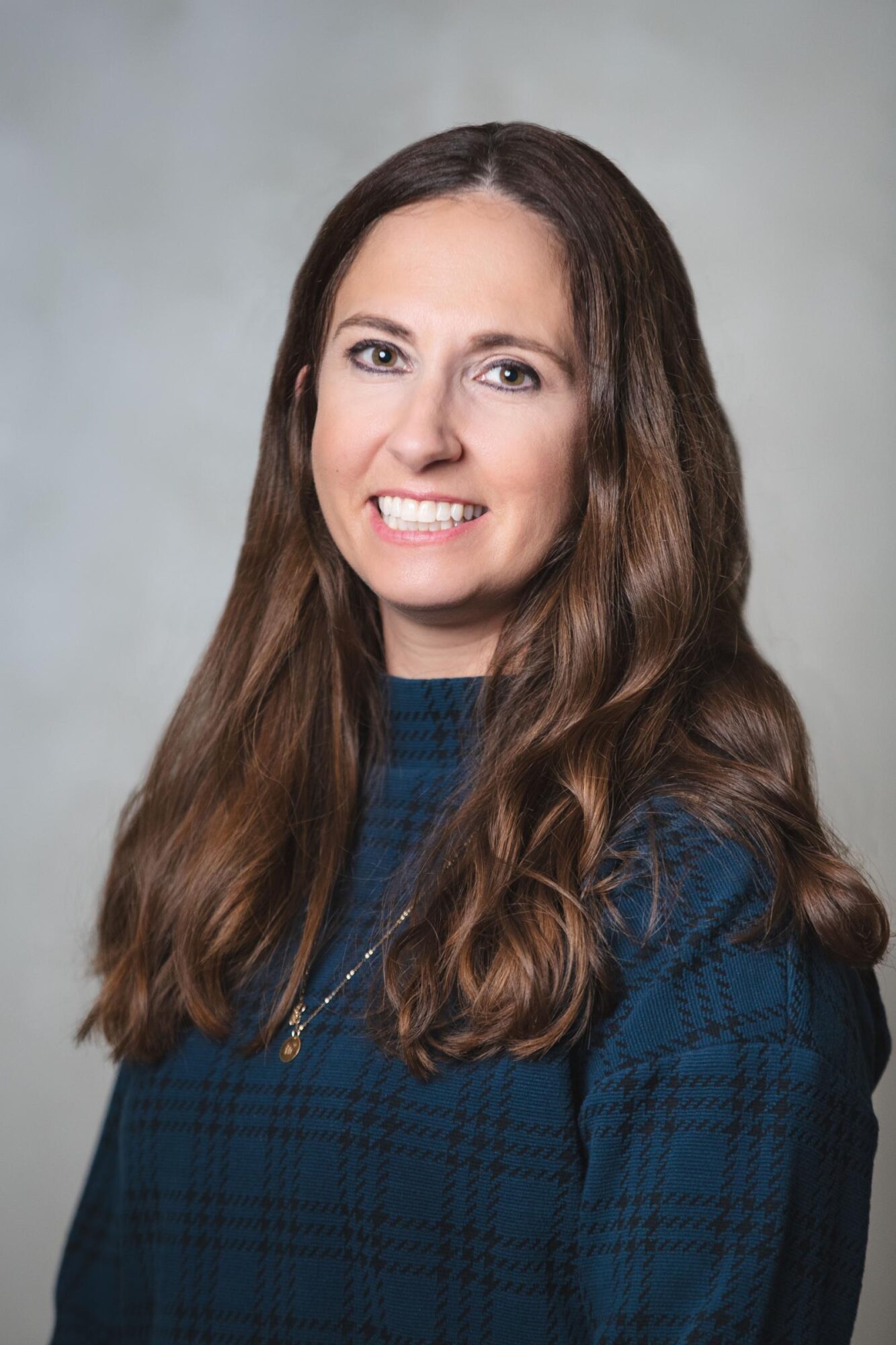 Dr. Fayth Johnston, Mont Belvieu orthodontist, smiling in a blue sweater, representing Johnston Family Orthodontics in Baytown, Texas.
